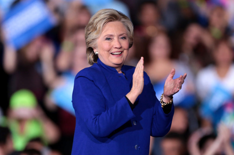 Photo of Hillary Clinton in blue outfit clapping