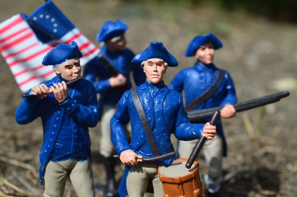 image of wax figures carrying military flag and drums