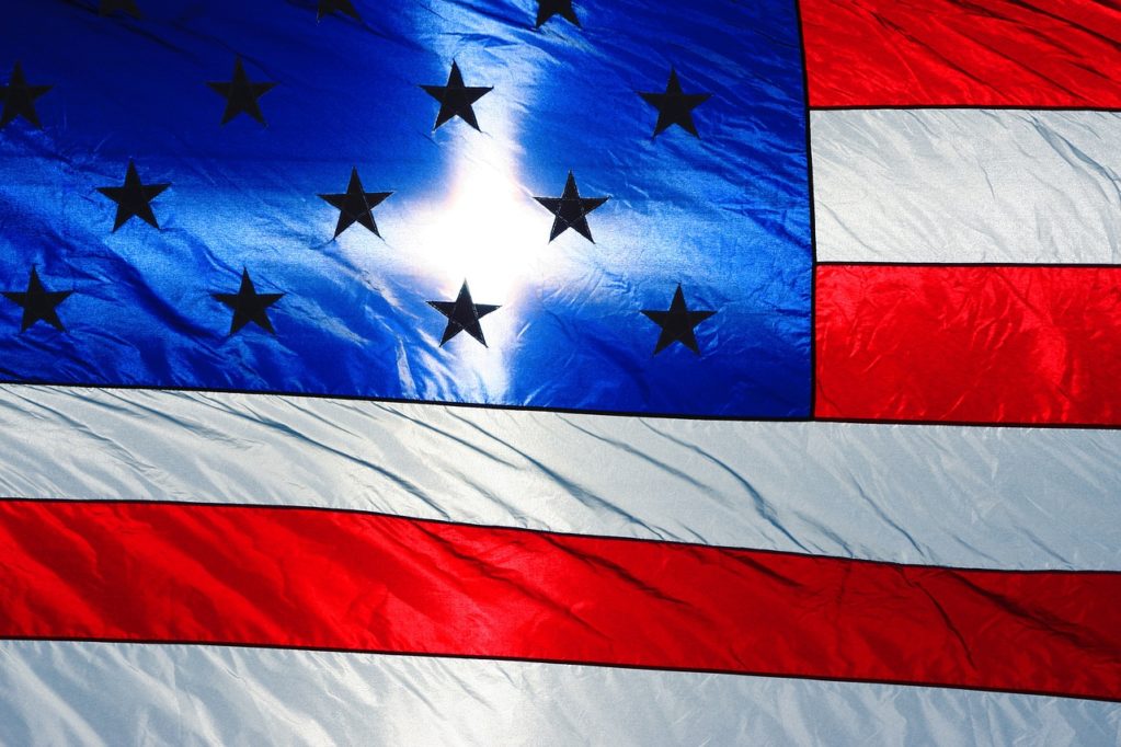 image of an american flag at sunrise with cross in center