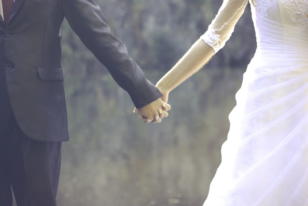 image of bride and groom holding hands