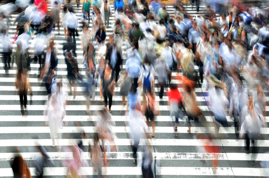 image of pedestrians on crosswalk with photo blurred from movement