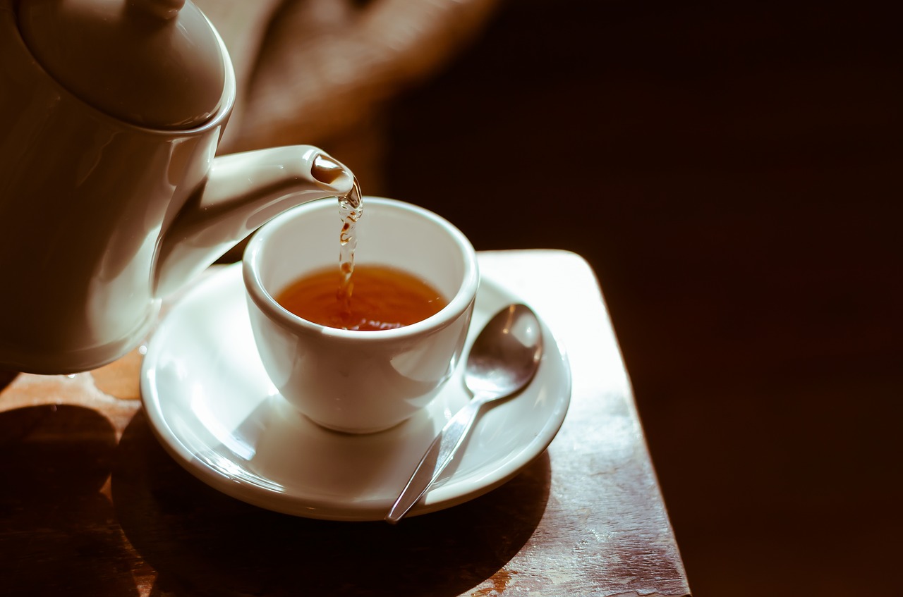 image of tea being poured into white cup