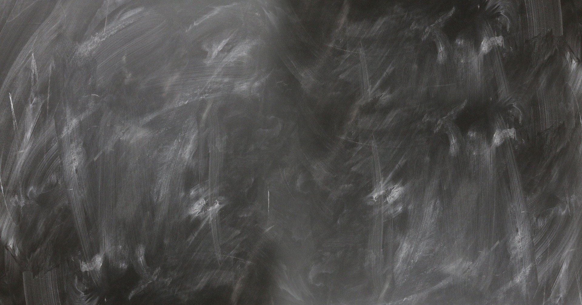 black chalkboard with white chalk eraser marks