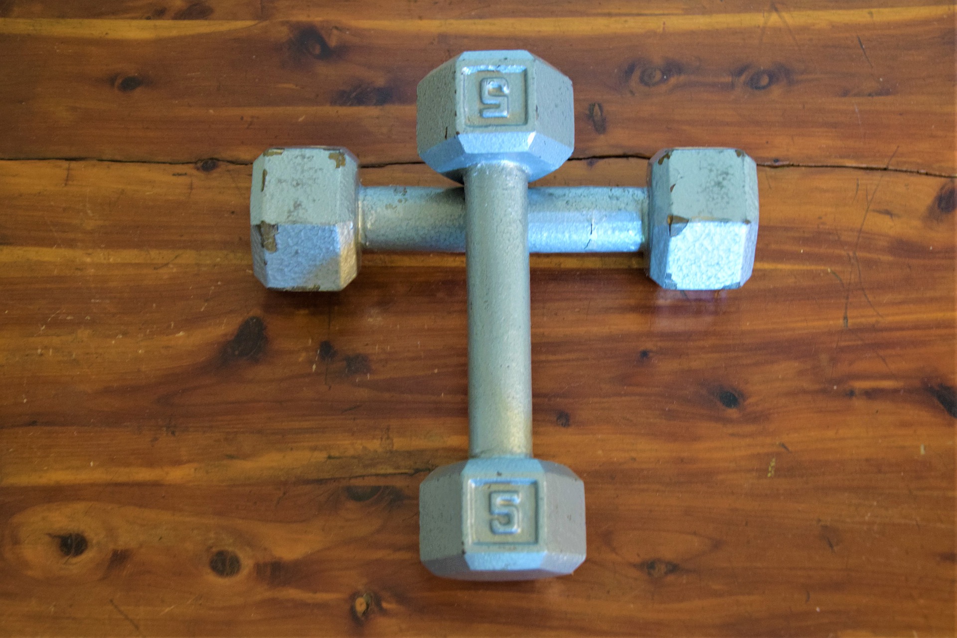 image of cross made out of barbells