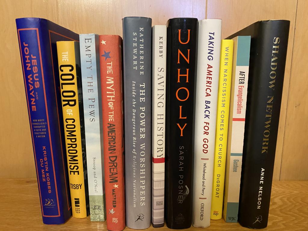 photo of books standing upright; on golden pine background